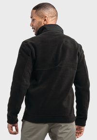 Schwarze Fleecejacke mit hohem Kragen und entspannter Passform. Besitzt lange Ärmel und verstärkte Nähte für Langlebigkeit. Rückansicht dargestellt.