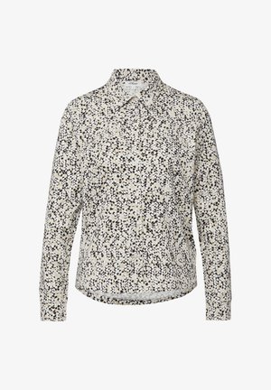 Chemise boutonnée avec une base crème clair et un motif de points noirs et bleu foncé dispersés. Dotée d'un col classique et de manches longues.