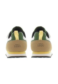 Retro-style sneakers featuring a white upper, green accents, yellow heel tab, and tan suede heel with "SINCE 1890" imprint. Rubber outsole.