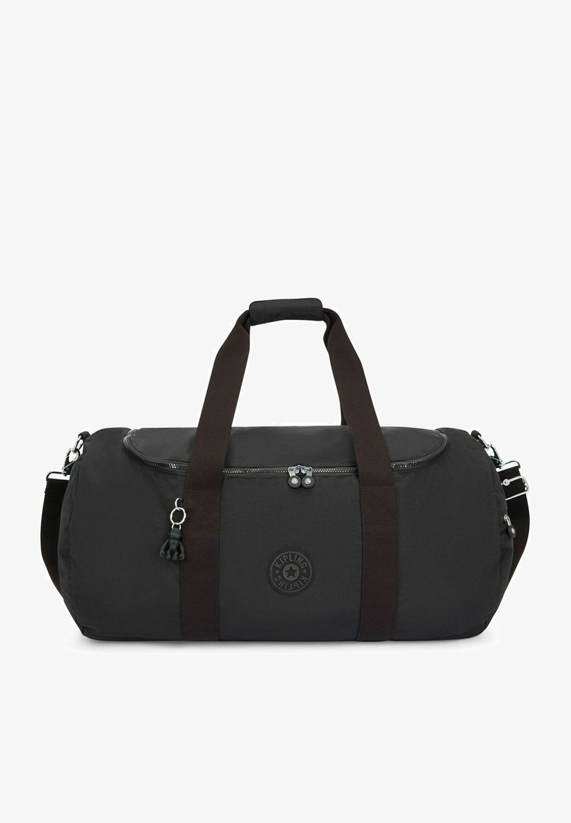 Black duffel bag made of fabric with a zippered top, reinforced handles, adjustable strap, and a round logo emblem on the side.