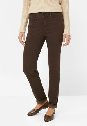 Brown cotton blend straight-leg jeans with five pockets, a button closure, and rolled cuffs, paired with brown textured flats.