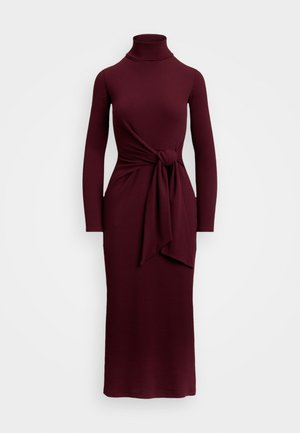 Burgundy long-sleeve dress with a mock turtleneck, featuring a knot detail at the waist and a fitted silhouette. Smooth texture, floor length.