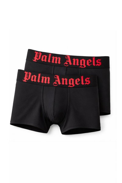 Δύο ζευγάρια μαύρα ανδρικά μπόξερ με φαρδιές ελαστικές ζώνες μέσης που φέρουν την επιγραφή «Palm Angels» με κόκκινα γοτθικά γράμματα.