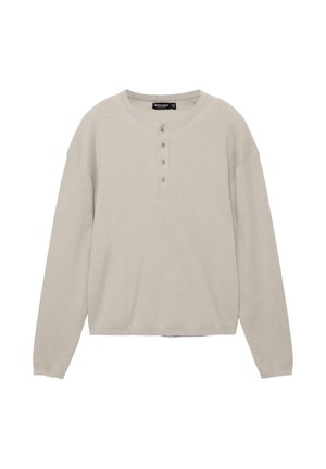 Világos bézs hosszú ujjú henley ing kerek nyakkivágással és négysoros gombsorral, bordázott textúra a vállakon és a mandzsettákon.