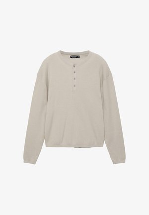 Lichtbeige heren henleyshirt met lange mouwen, ronde hals en vier knopen, geribbelde textuur op schouders en manchetten.