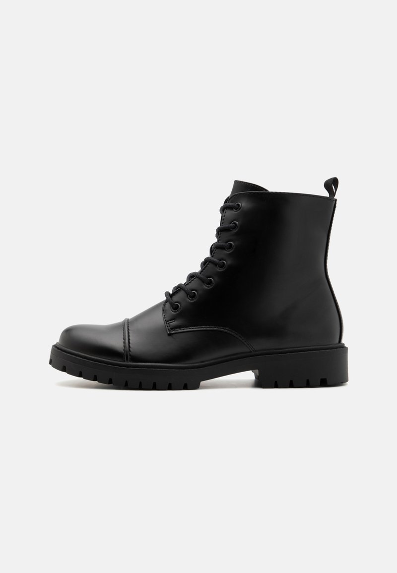 Black leather lace-up ankle boots with a smooth finish, rounded toe, and chunky rubber sole featuring deep tread. Pull tab at the back.