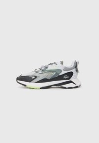 Lacoste sneakers featuring a gray and black mesh upper, reflective accents, and a green outsole, designed with a padded collar and laces.