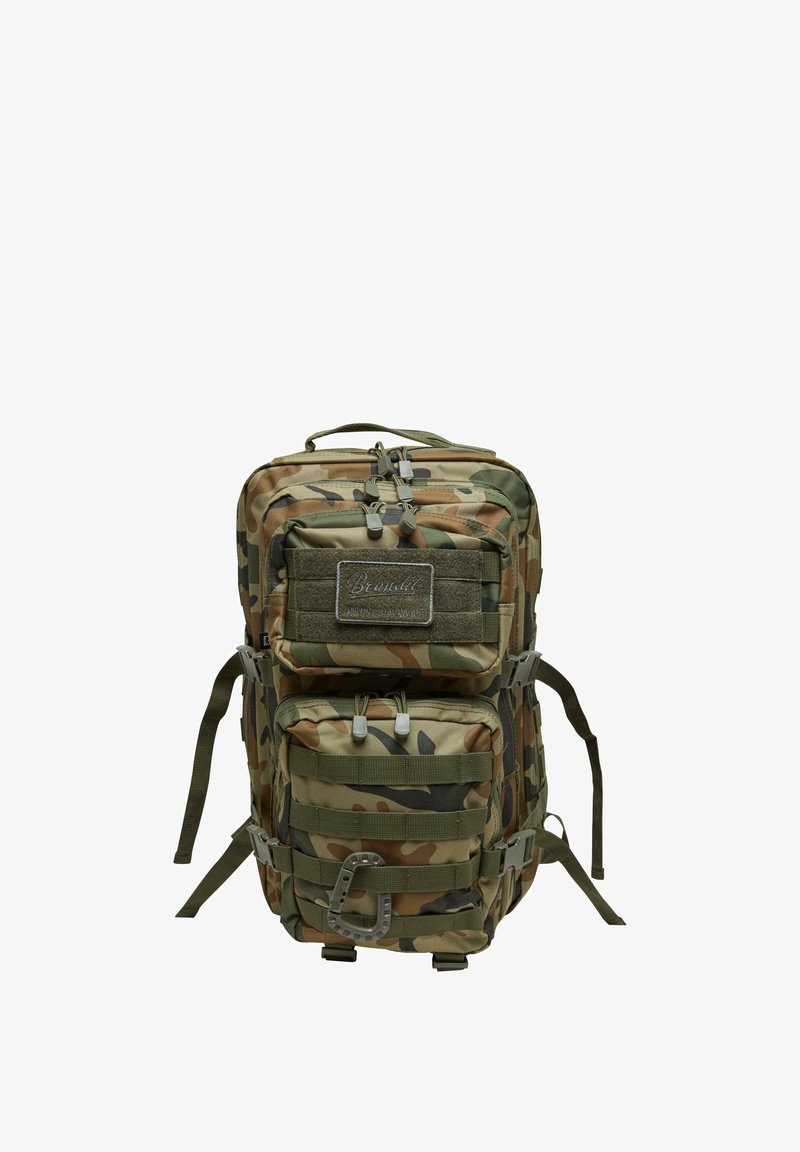 Kamuflāžas mugursoma ar vairākiem rāvējslēdzēju nodalījumiem, mīkstām plecu siksnām un augšējo rokturi. Strukturēta auduma ar nostiprinātām šuvēm.