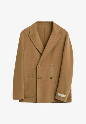 Blazer doppiopetto in lana marrone con rever a punta, due tasche frontali e bottoni decorativi dorati. Presenta un'etichetta del marchio sull'orlo.