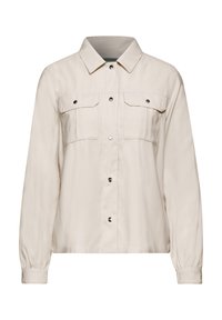 Beige långärmad skjortjacka med knäppt front, två bröstfickor med klaff och tryckknappar, samt en spetsig krage.