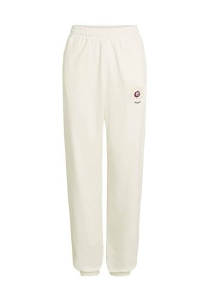 Cream-colored sweatpants with an elastic waistband, tapered cuffs, and a small embroidered sun logo in maroon and beige on the left thigh.