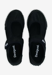 Black athletic shoes with a fabric upper, rubber sole, and velcro strap. Features rounded toe and textured grip for traction.