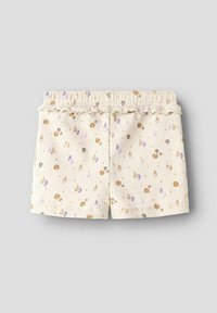 Un short couleur crème avec une taille élastique froncée, orné de petits motifs de coquillages et de gouttes dans des tons dorés, violets et marron.