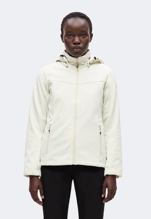 Person wearing a light cream zip-up jacket with a hood, standing facing forward against a plain light background.