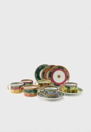 Seven ornate teacups with matching saucers in purple, green, orange, yellow, and pink, featuring gold and leafy decorative patterns.