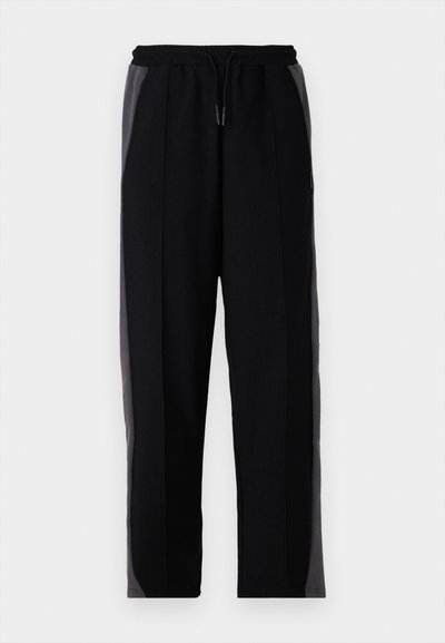 Pantaloni de jogging negri cu panouri laterale gri, având un elastic în talie cu șnur de ajustare, textură netedă și un design cu picior tapered.