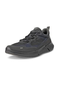 Black athletic shoe with a textured upper, mesh panels, and reflective accents. Features a cushioned sole and lace-up closure for support.