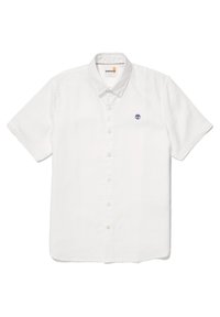 Camisa de lino blanca de manga corta con botón, que presenta un pequeño logo de un árbol azul en el pecho, con cuello clásico y dobladillo recto.