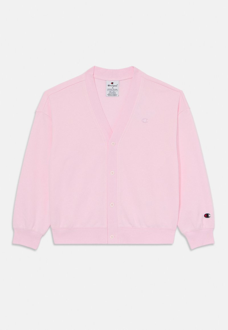 Rožinė megztinė su V formos iškirpte, priekine knopke, reljefinėmis rankovėmis ir apatine dalimi, ir mažu logotipu krūtinėje bei rankovėje. Pagamintas iš minkštos mezgimo medžiagos.