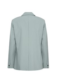 Világoskék, testre szabott zakó, strukturált sziluettel, kihajtott gallérral és gombos mandzsettával. Simaságával és minimalista részleteivel kiemelkedő textúra.