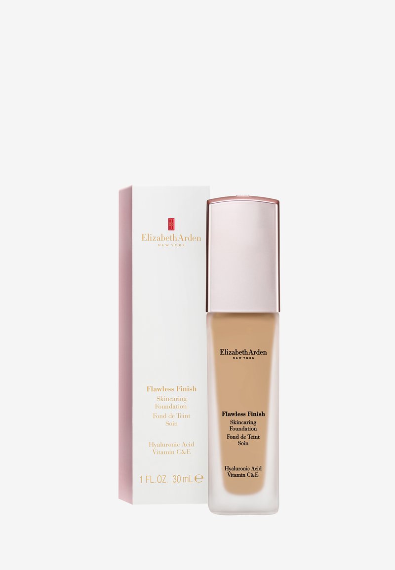 Elizabeth Arden Flawless Finish Skincare Foundation bottle and box with pink cap, featuring hyaluronic acid and vitamins C and E.