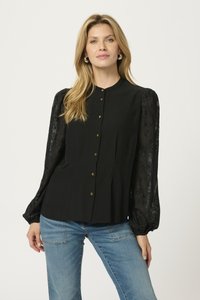 Black blouse with a high collar, button front, and sheer, patterned puff sleeves. The fabric is smooth with subtle textural details.