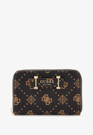 Black Guess zip-around wallet with brown repeating logo pattern and gold "GUESS EST 1981" plaque on front.