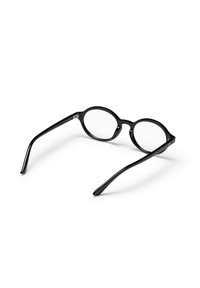 Μαύρα στρογγυλά γυαλιά με διάφανα φακούς, λεία πλαστική επιφάνεια, φαρδιές πλευρές και χωρίς ορατά λογότυπα ή διακοσμήσεις.