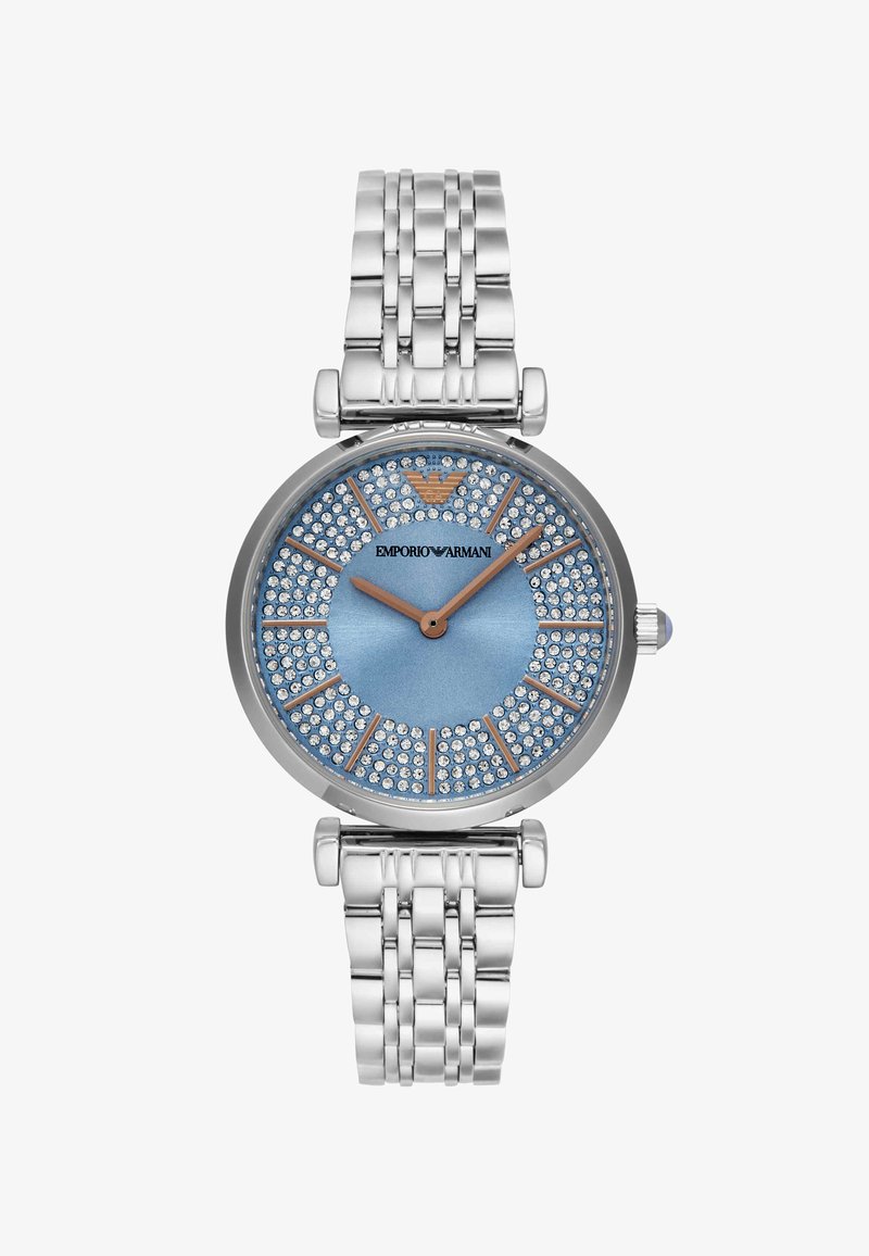 Ceas metalic argintiu cu față albastră, ace și marcaje aur roz, ornamente cu cristale și logo Emporio Armani la ora 12.