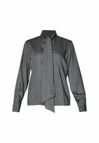 Blouse à manches longues à carreaux noirs et blancs avec col montant et détail de nœud à l'avant, présentée sur un fond blanc.