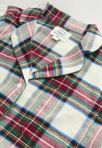 Collared plaid shirt with green, red, white, and blue checks, buttoned front, and a pocket on the chest.