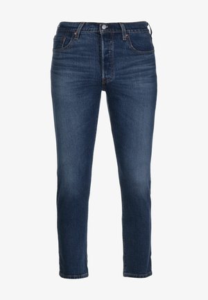 Mörkblå denimjeans med slim fit, med en femfickdesign, en knappgylf och subtila sömnadsdetaljer längs sömmarna.