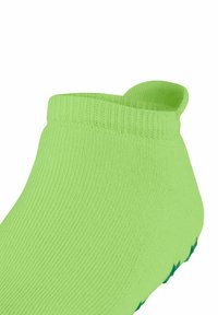Grüne Knöchelsocke aus geripptem Stoff, mit einem umgeschlagenen Rand und einer strukturierten Sohle mit einem rutschfesten Muster.