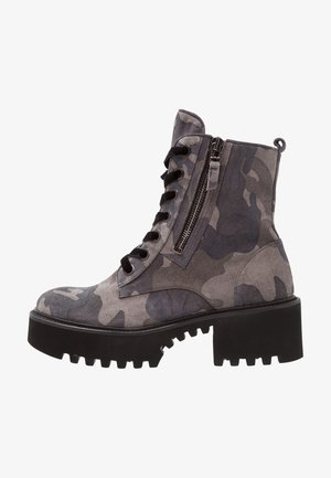 Gray camo suede ankle boots with black lace-up front and side zipper, featuring a thick black rubber sole and rugged tread for traction.