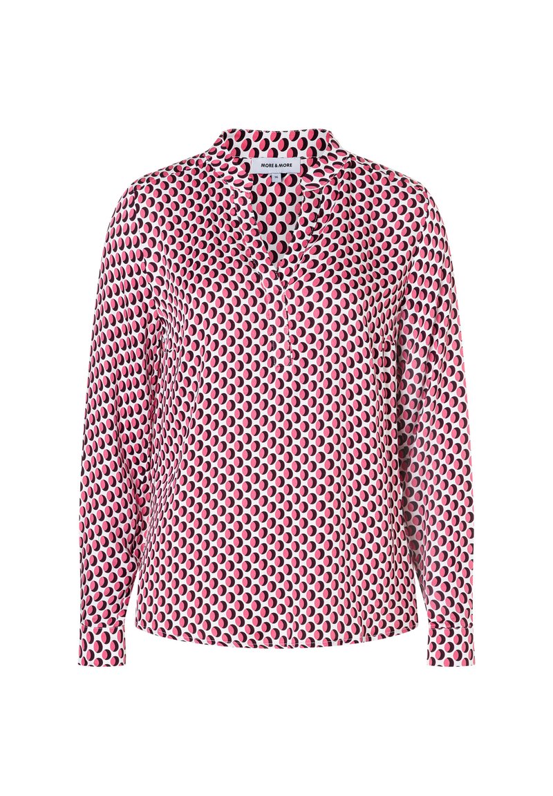 Langärmlige Bluse mit rosanem, schwarzem und weißem kreisförmigem Muster, V-Ausschnitt und mit Manschetten versehenen Ärmeln, Vorderansicht vor weißem Hintergrund.