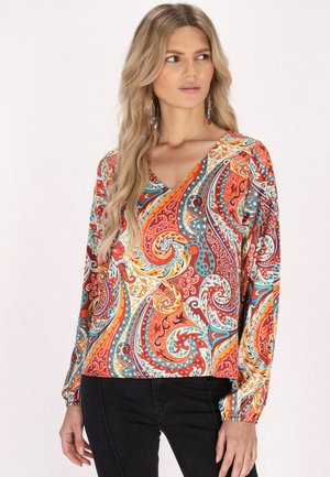 Blusa a maniche lunghe con vivace motivo paisley in colori rosso, arancio, blu e giallo. Presenta un collo a V e polsini delle maniche arricciati.