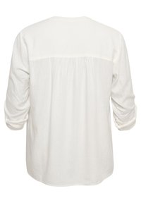 Blouse blanche à manches longues, en tissu léger avec un détail plissé dans le dos, ourlet arrondi et poignets retroussés.