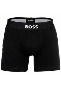 Svarta boxertrosor i bomull, med en vit logoband i midjan, en snug passform och en klassisk design.