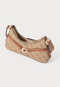 Beige patterned shoulder bag with brown accents and a gold-tone logo clasp. Zippered closure, structured shape, and adjustable strap.