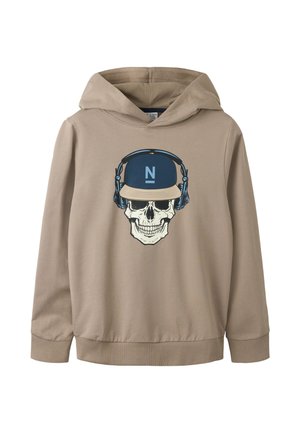 Sweat à capuche beige avec un graphisme d'un crâne portant une casquette bleue et beige et un casque audio bleu sur le devant.