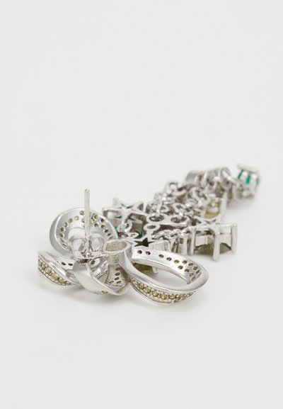 Silver metal earring featuring a three-dimensional design with perforated loops and a chain-like structure, adorned with colorful accents.