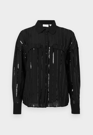 Schwarze Hemdjacke mit gestreiftem, durchscheinendem Stoff und metallischen Akzenten. Mit Kragen, zwei Brusttaschen und langen, umgeschlagenen Ärmeln.