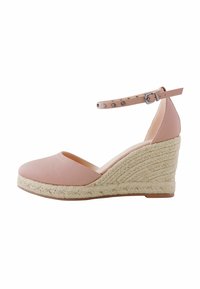 Pink leather wedge shoe with a rounded toe, espadrille-style woven jute sole, and an ankle strap featuring decorative studs.