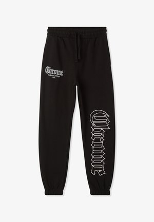 Pantaloni della tuta neri realizzati in morbido tessuto, dotati di vita elastica e polsini, con dettagli in bianco stampati su entrambi i lati.