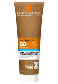 Sunscreen lotion in a brown squeeze tube, featuring a white lower section. Key details include high SPF 50+, waterproof, and eco-conscious branding.