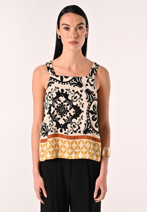 Top senza maniche con un motivo floreale bianco e nero e una stampa geometrica arancione e gialla all'orlo. Realizzato in tessuto testurizzato.