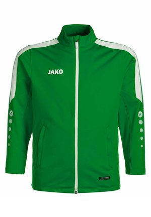 Groene sportjack met witte accenten, hoge kraag, volle rits en zijzakken. Bevat het logo "JAKO" en een cirkelpatroon op de mouwen.