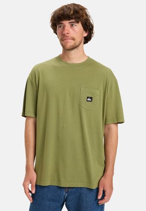 Olive green cotton t-shirt with short sleeves, round neckline, and chest pocket featuring a black logo patch. Casual fit and lightweight texture.