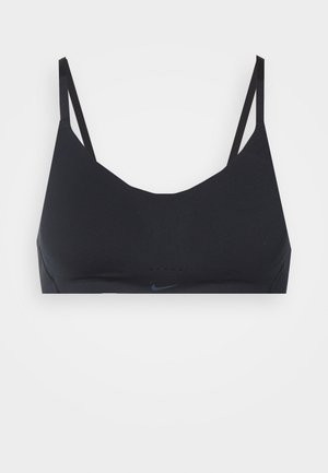 Black sports bra with a smooth, stretchy fabric. Features thin straps, a scoop neckline, and subtle Nike logo. Seamless design for comfort.