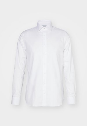 Biała koszula z długim rękawem, wykonana z bawełny, z kołnierzykiem, z przodu zapinaną na guziki oraz dopasowanym krojem z bocznymi rozcięciami u dołu.